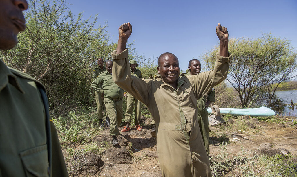 Simbiri Toki cheers after the successful transaction of Asiwa, a Rothschild's (Nubian) giraffe.